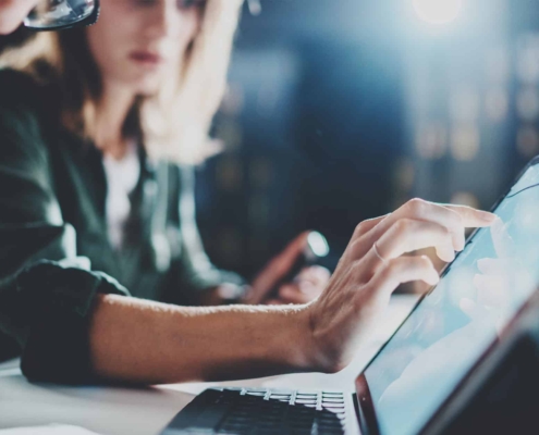 Two-employees-using-touch-computer