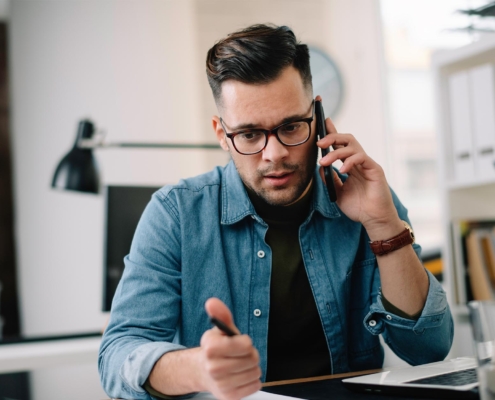 Worker at office desk on phone call